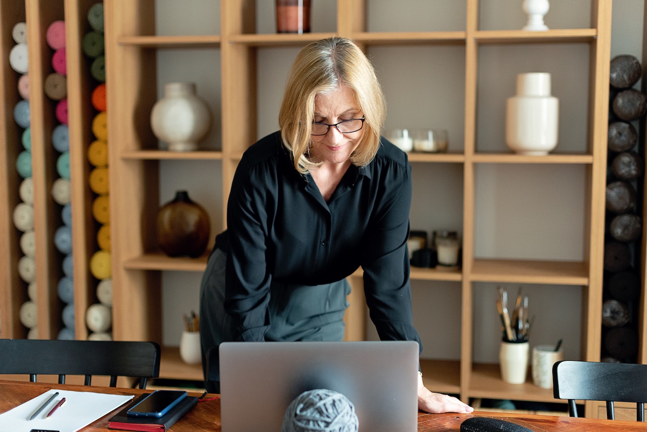 A woman in a black shirt using a computer