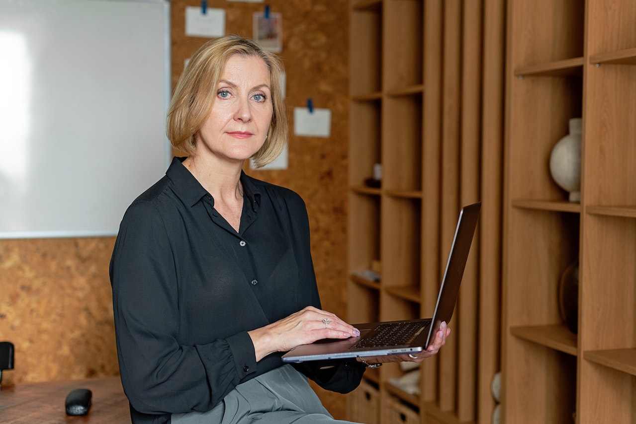 a woman using a laptop inside an office