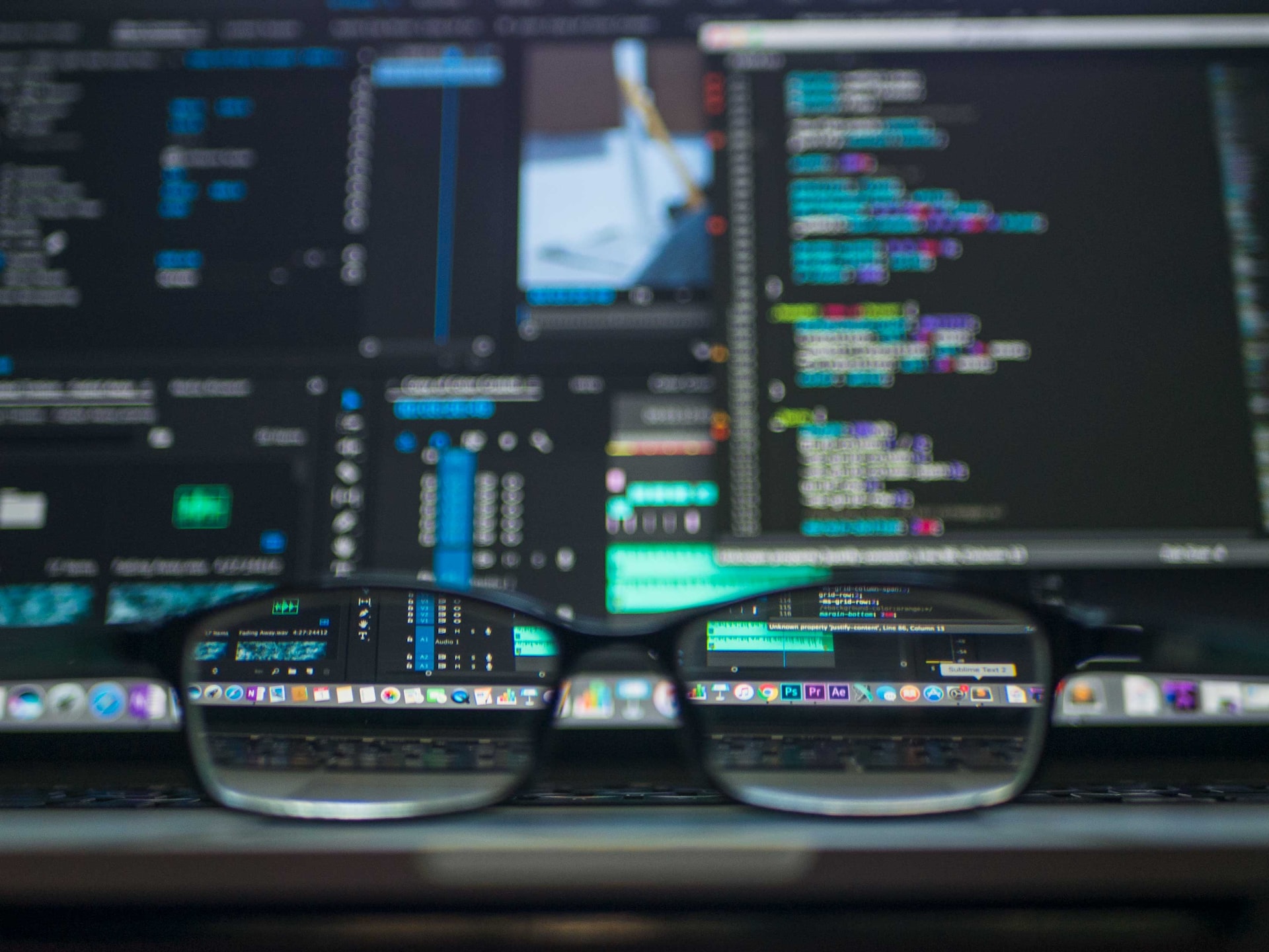 A picture of glasses and a computer screen with code